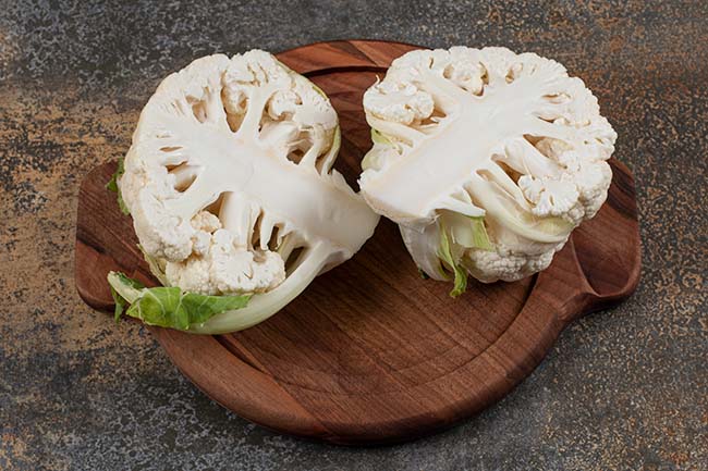 cauliflower-sliced-two-pieces-board-marble-surface