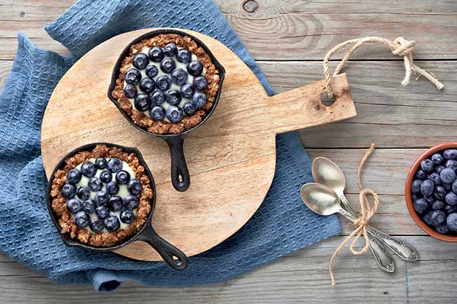 delicious-blueberry-tartlets-with-vanilla-custard-cream-tarts-are-rustic-wooden-board-blue-textile-towel-wood-planks