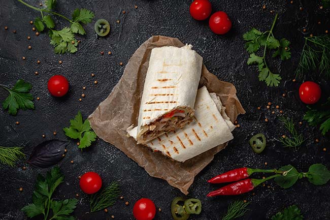 delicious-shawarma-lavash-tacos-dark-stone-table-fast-food-restaurant-healthy-option-fast-food-tasty-fresh-wrap-sandwiches-with-beef-meat-vegetables-traditional-middle-eastern-snac