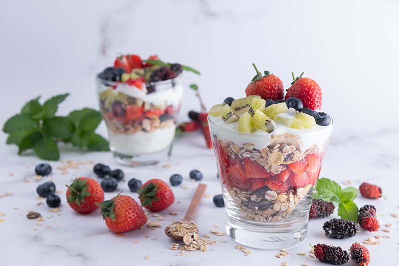 homemade-muesli-bowl-oat-granola-with-yogurt-fresh-blueberries-mulberry-strawberries-kiwi-mint-nuts-board-healthy-breakfast-copy-space-healthy-breakfast-concept-clean-eating