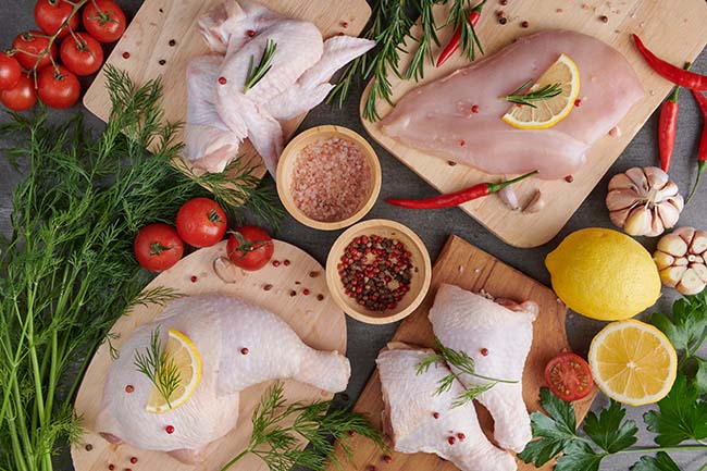 raw-chicken-fillet-with-garlic-pepper-rosemary-wooden-chopping-board